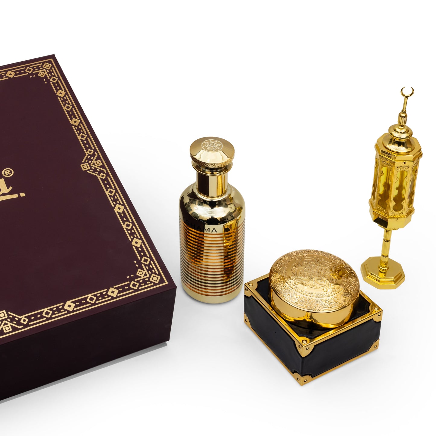 Shama perfume set with a gold bottle, container, and decorative item on a white background