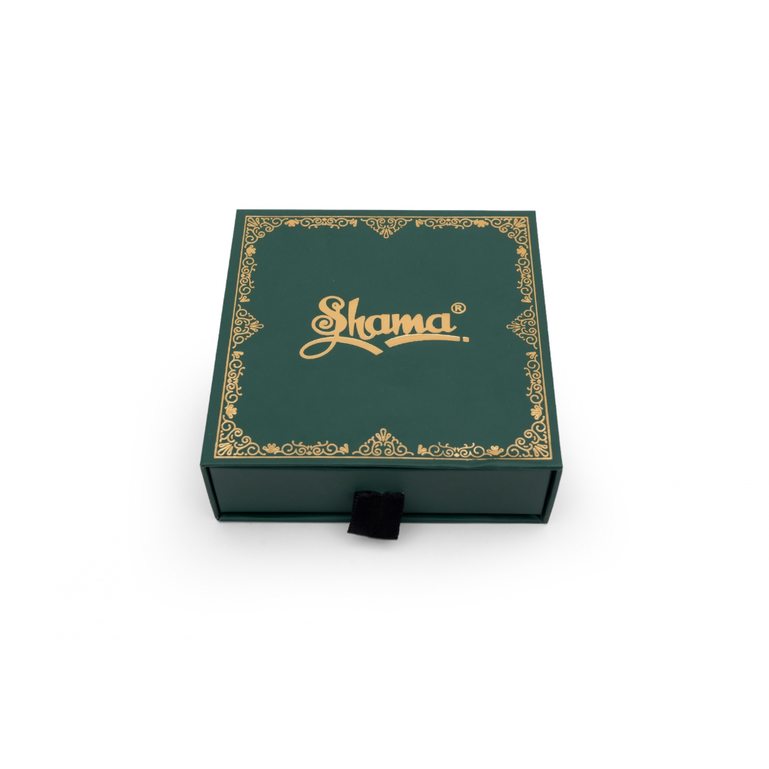 Green jewelry box with gold accents and 'Shama' branding on a white background