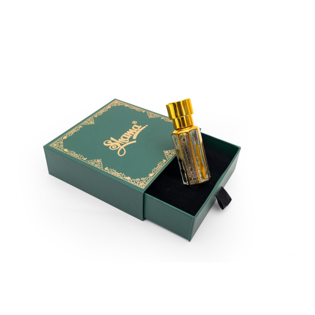 Perfume bottle with gold cap in a green box on a white background